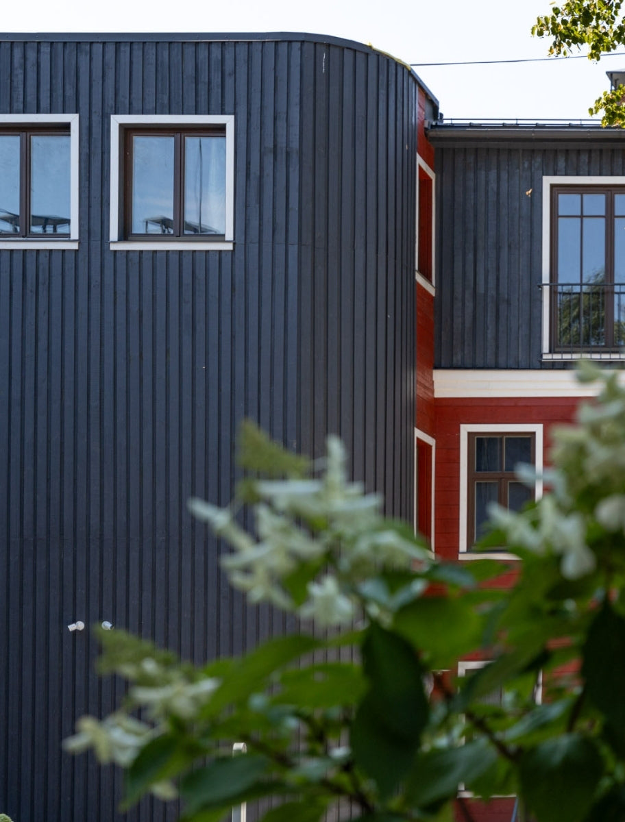 Exterior of a wooden house painted with Paint Eco Natural Paint In Graphite shade.