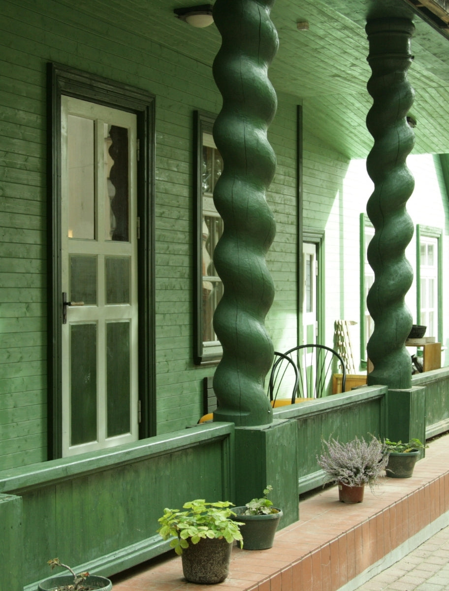 Exterior of a wooden house painted with Paint Eco Natural Paint In Needle shade.