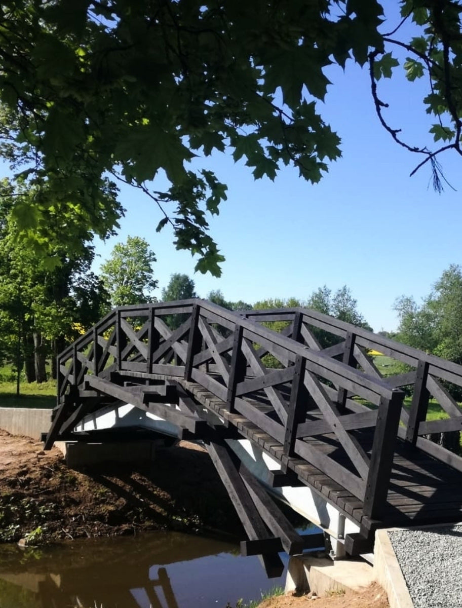 A wooden bridge painted with Paint Eco natural paint, showcasing a smooth and even finish in an earthy tone.