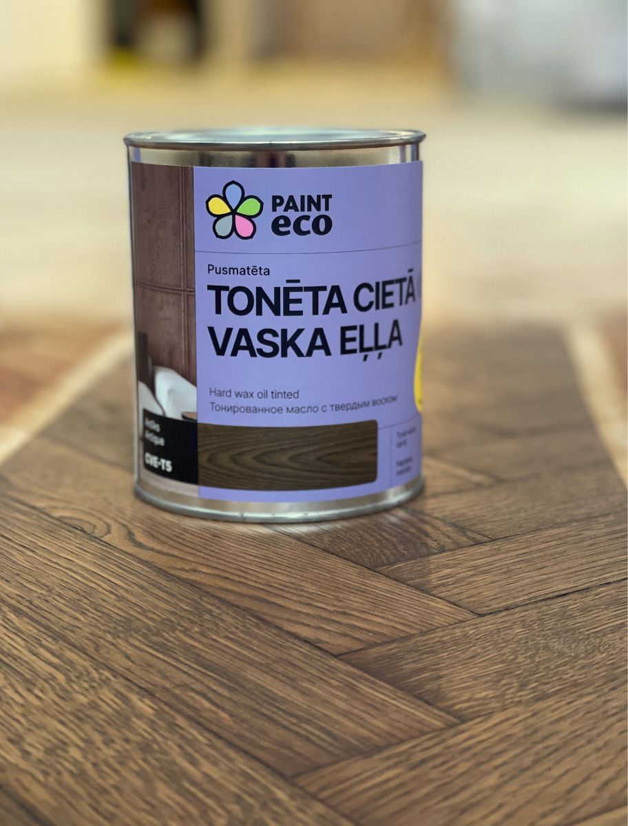 Paint Eco Tinted Hard Wax Oil can on wooden parquet with a rich brown shade
