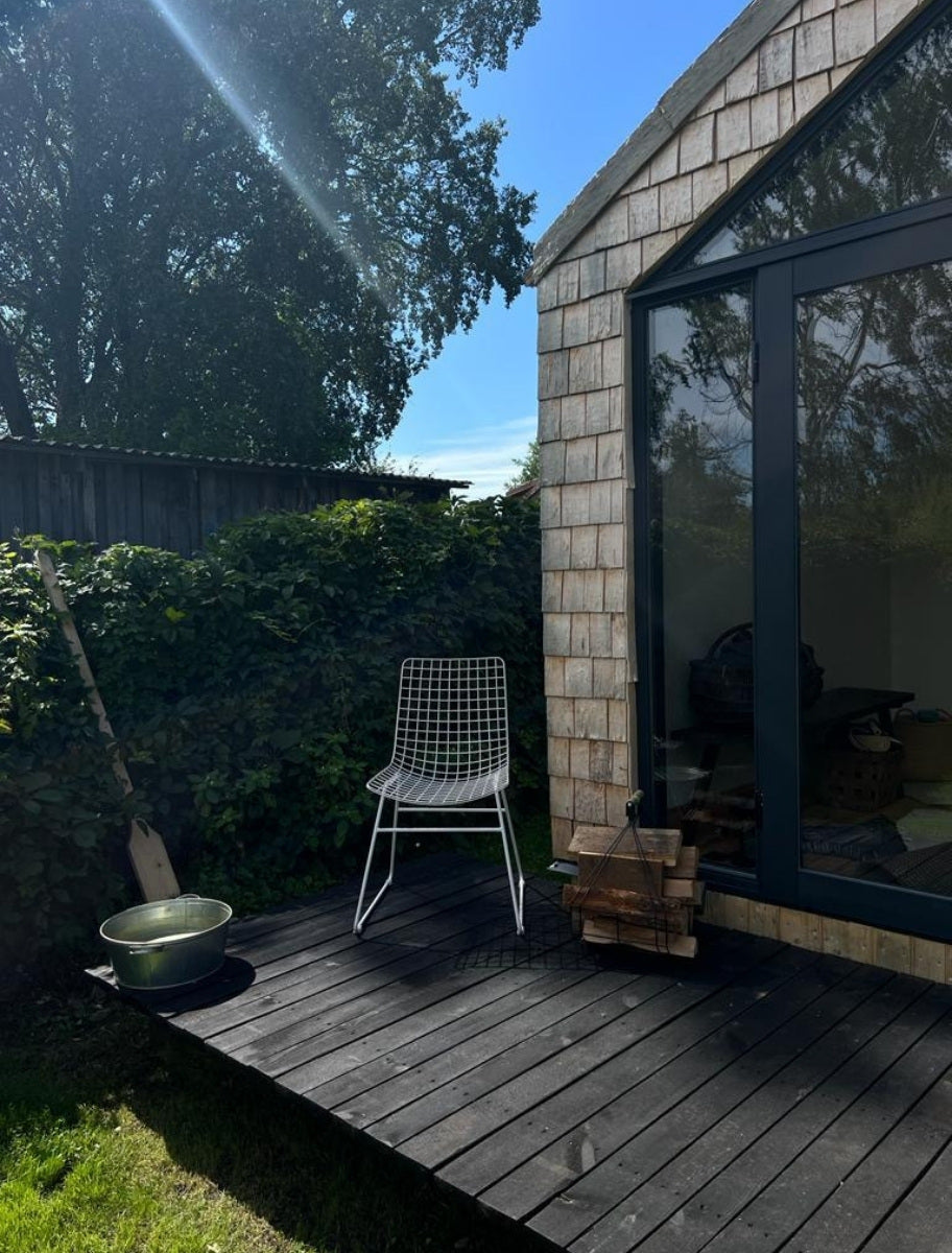 A wooden terrace coated with Paint Eco natural paint, highlighting its rich color and protective finish for outdoor durability.