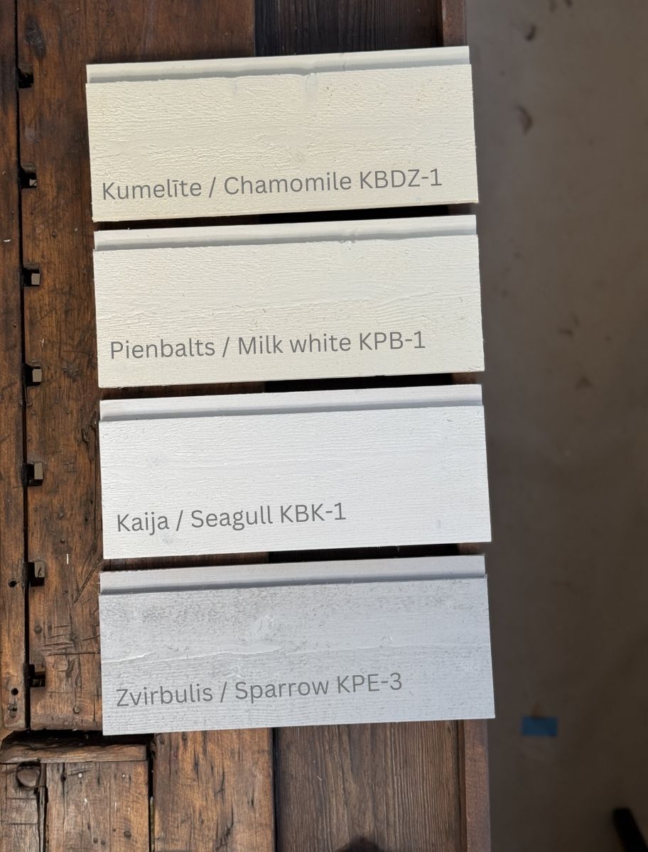 Comparison of four wooden boards painted with different shades of Paint Eco linseed oil-based paint in color variations, showcasing the natural finish and coverage for interior and exterior wood surfaces.