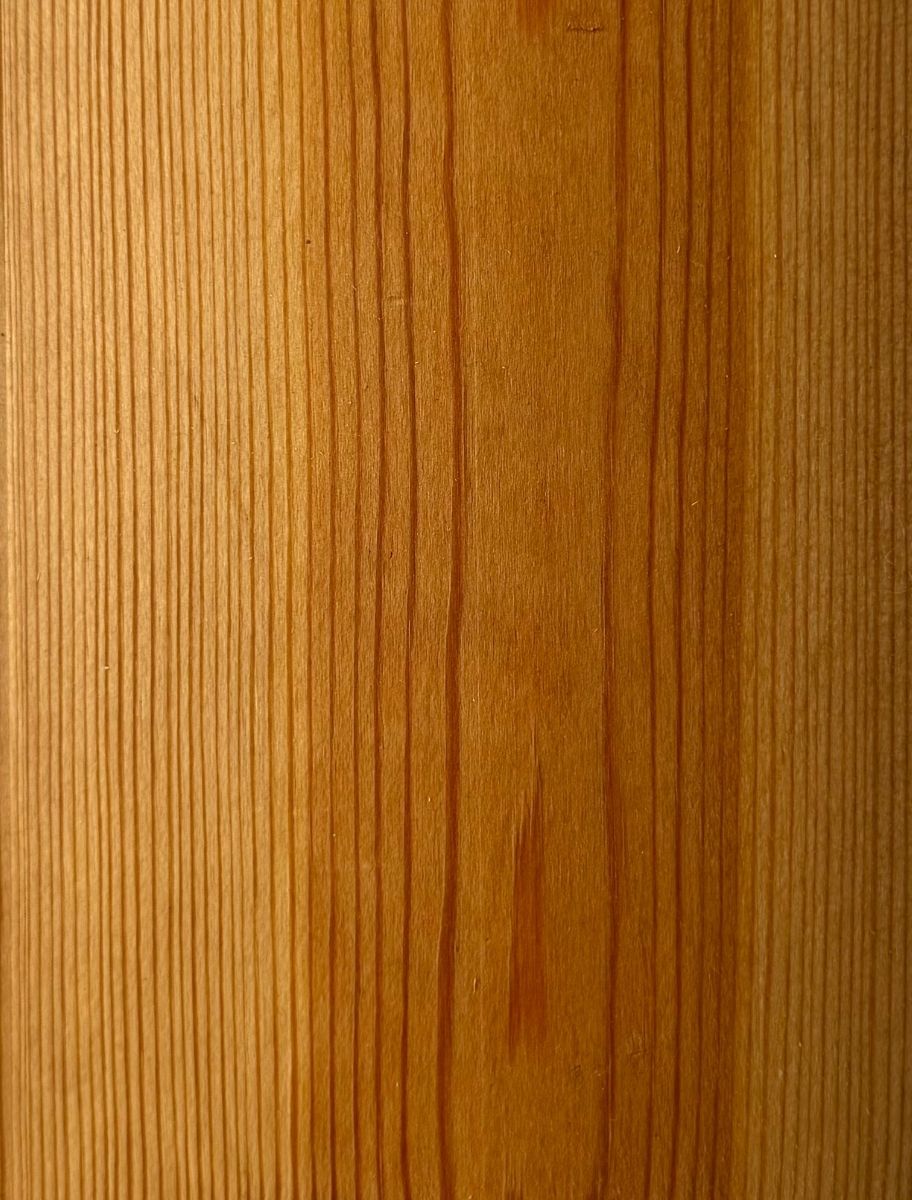 Close-up of wooden surface treated with PAINT ECO Tar Oil, highlighting rich color and smooth finish.