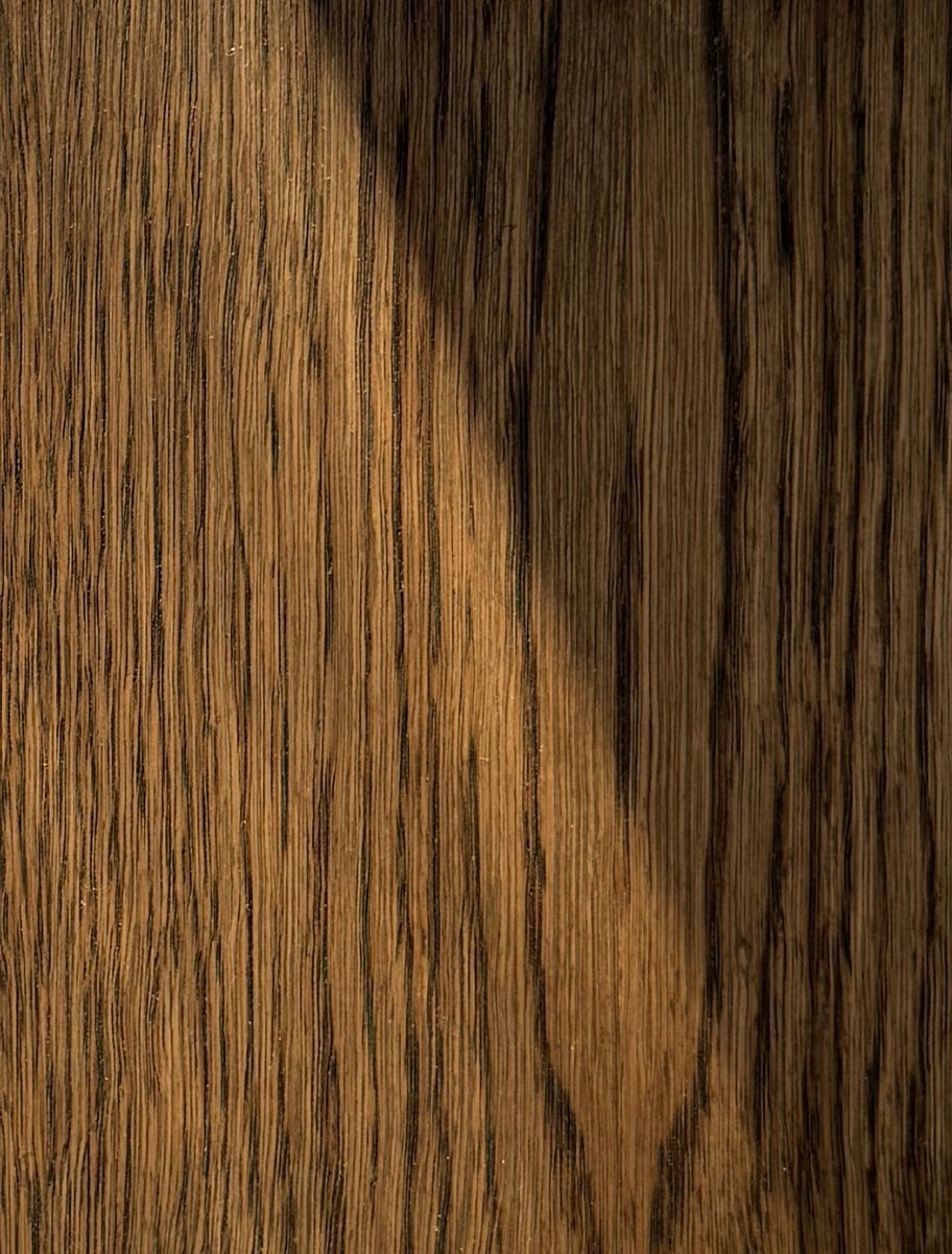 Close-up of a darker wooden surface finished with Paint Eco Tinted Hard Wax Oil in Dark Oak shade