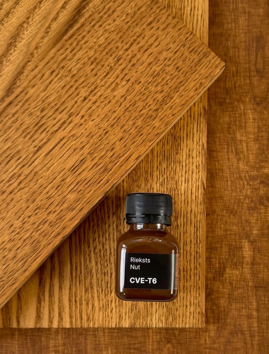 Small Paint Eco oil sample bottle placed on a different wooden plank in Nut shade
