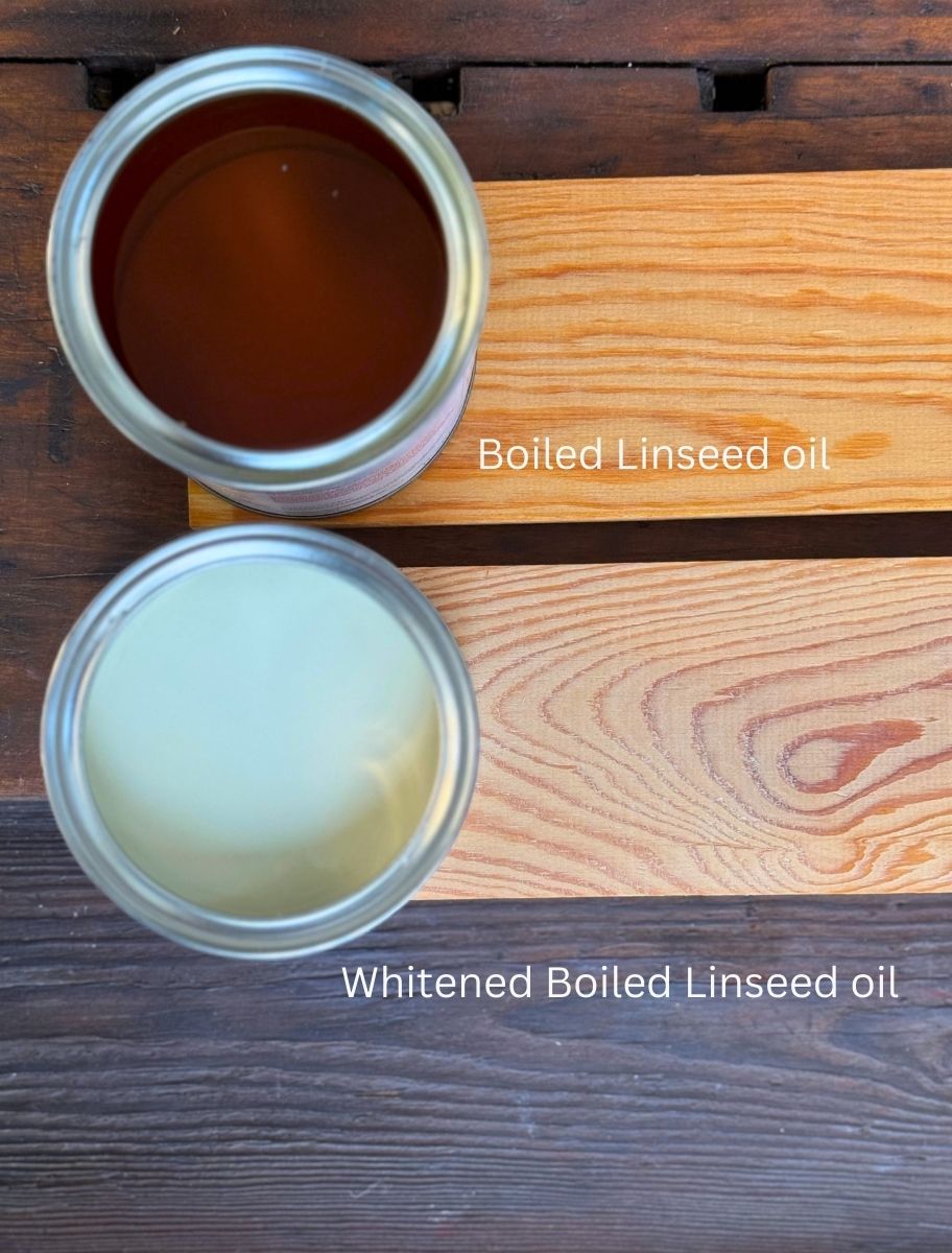 A comparison of two linseed oils—one dark brown boiled linseed oil and one lighter, whitened boiled linseed oil—shown in open cans next to treated wooden surfaces.