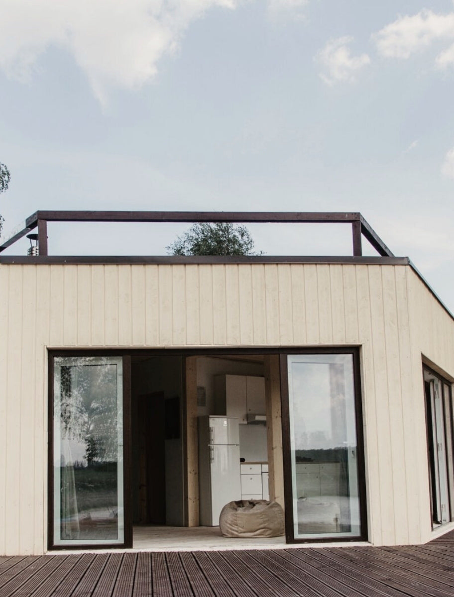 Exterior of a wooden house painted with Paint Eco Natural Paint In Chamomile shade.