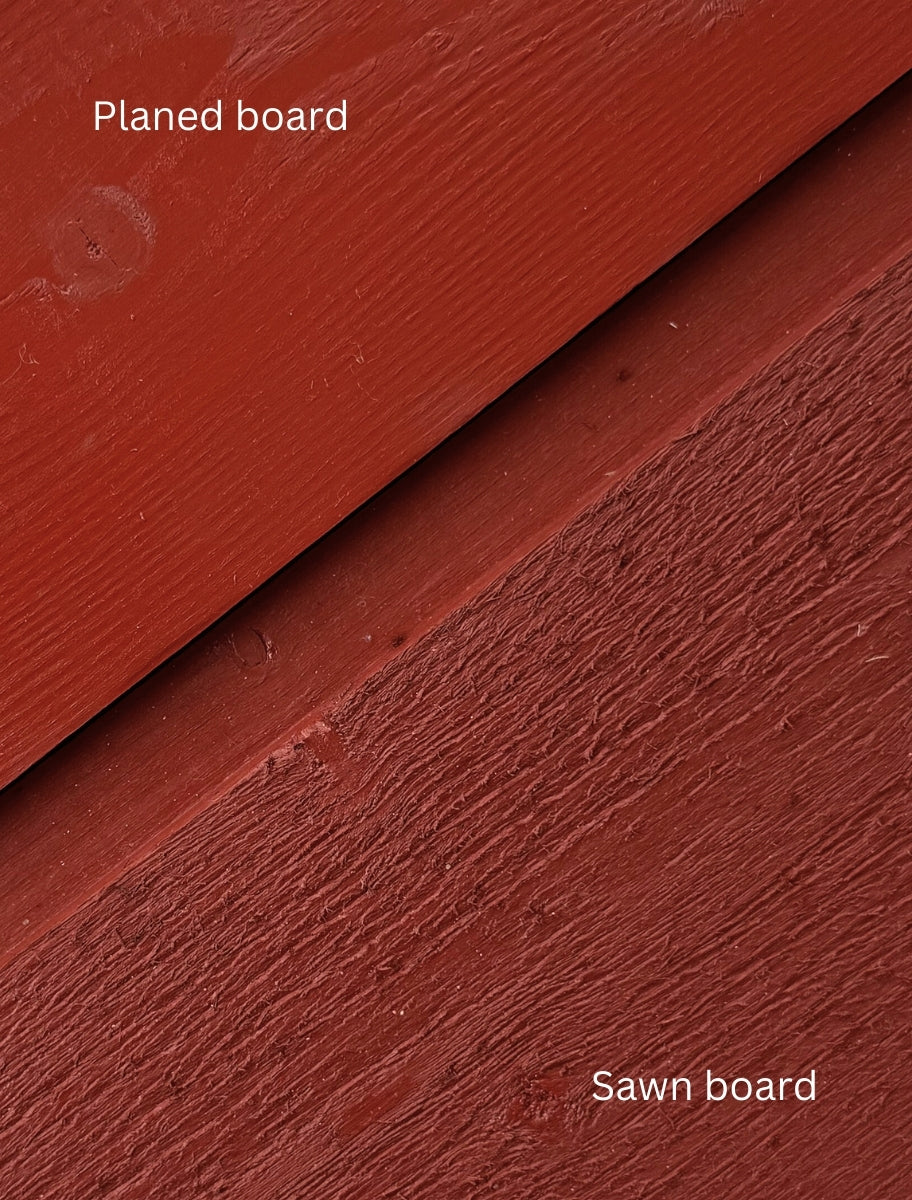 Close-up of a wooden board painted with Paint Eco natural paint, showing a smooth and textured wood finish in Swedish red shade.
